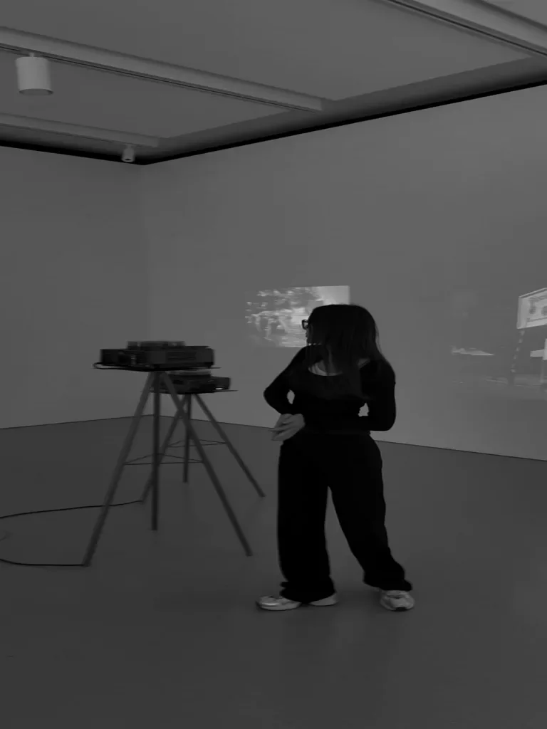 A woman in a studio next to a projector