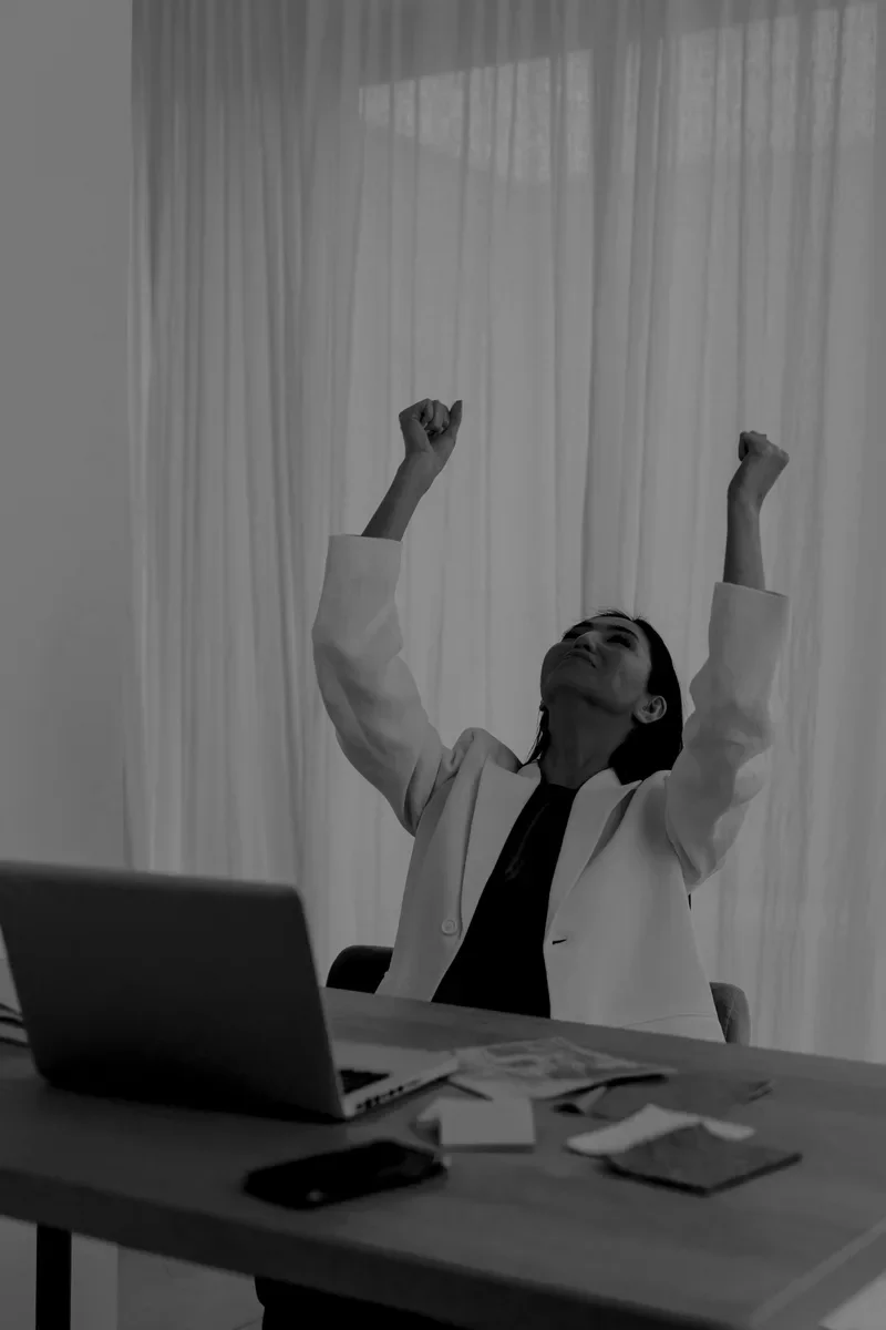 A woman in white raising both arms